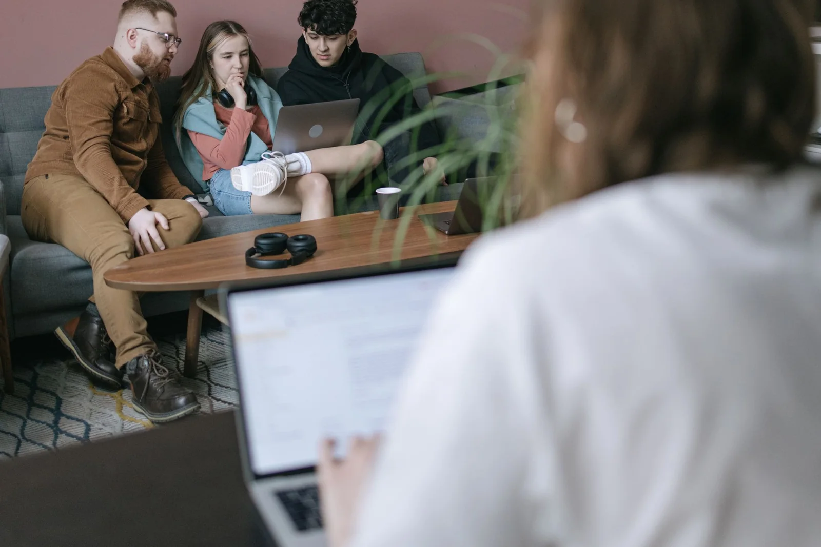 Business team examining a controlled AI-assisted workflow on a laptop.