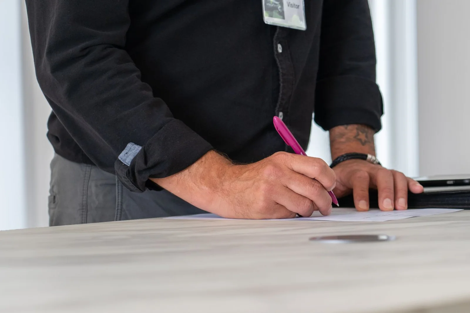 Founder reviewing and signing a prepared business funding document.