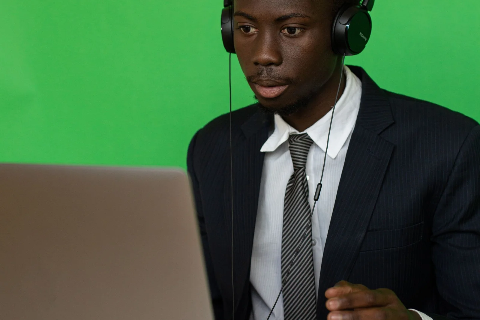 Business professional preparing virtual-operations evidence on a laptop.