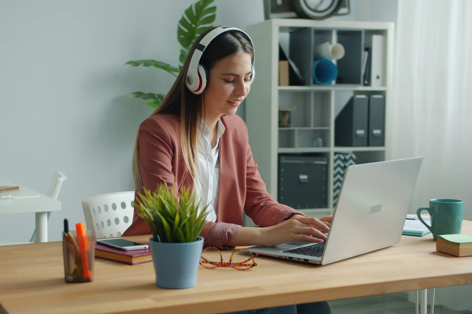 Customer support professional working with a headset and laptop.