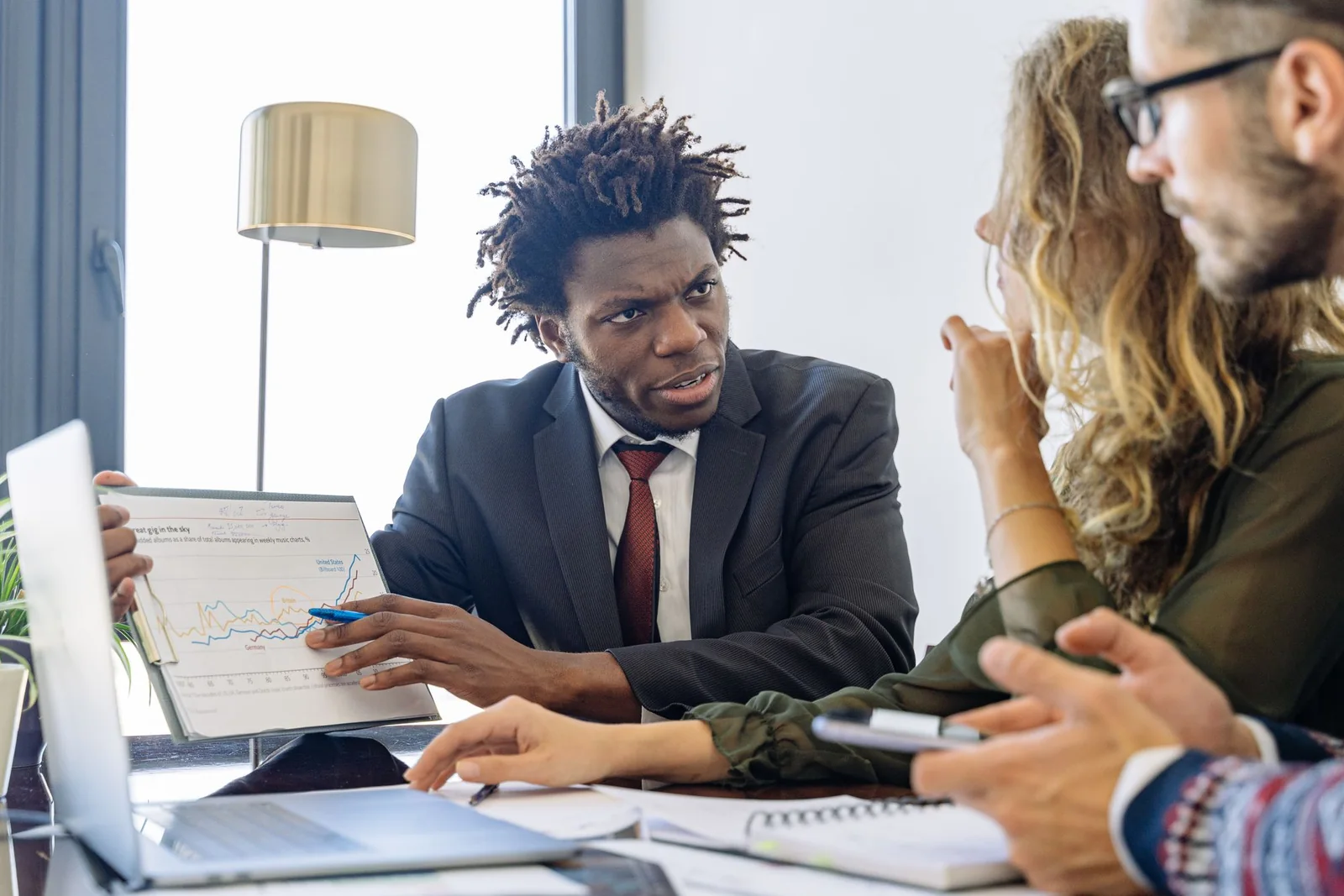 Business development professional holding a focused conversation with prospective clients.