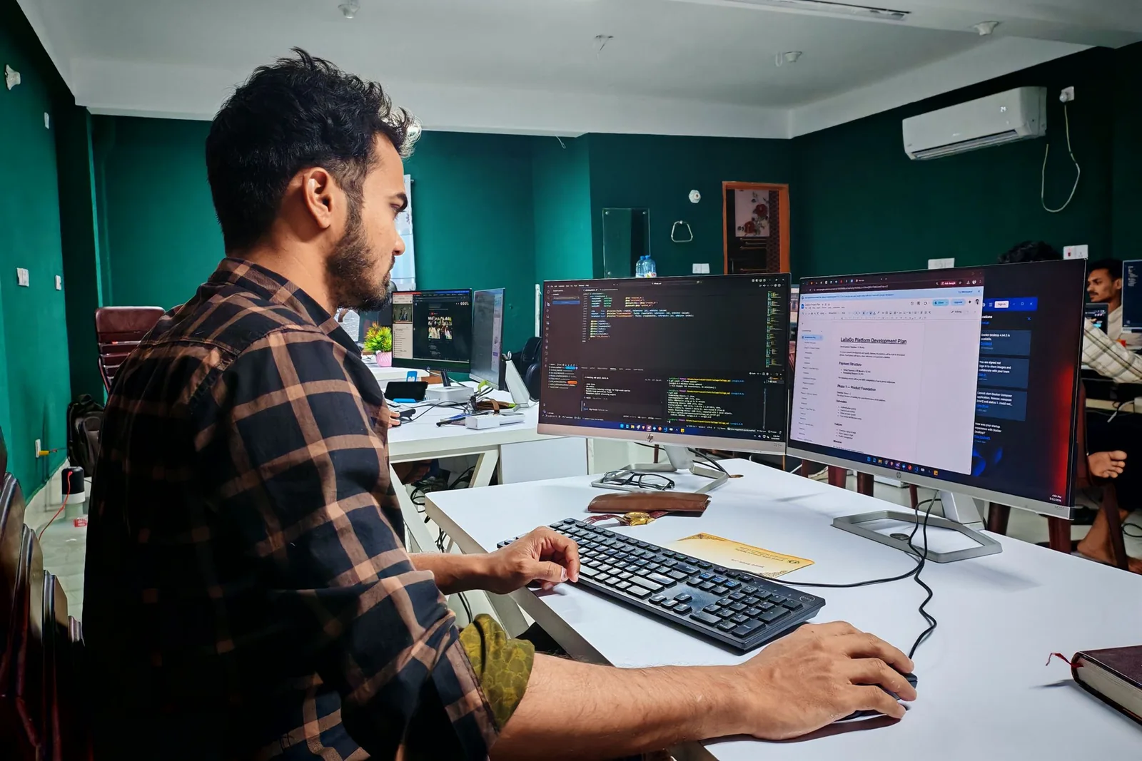 Developer testing and reviewing software code in a modern office.