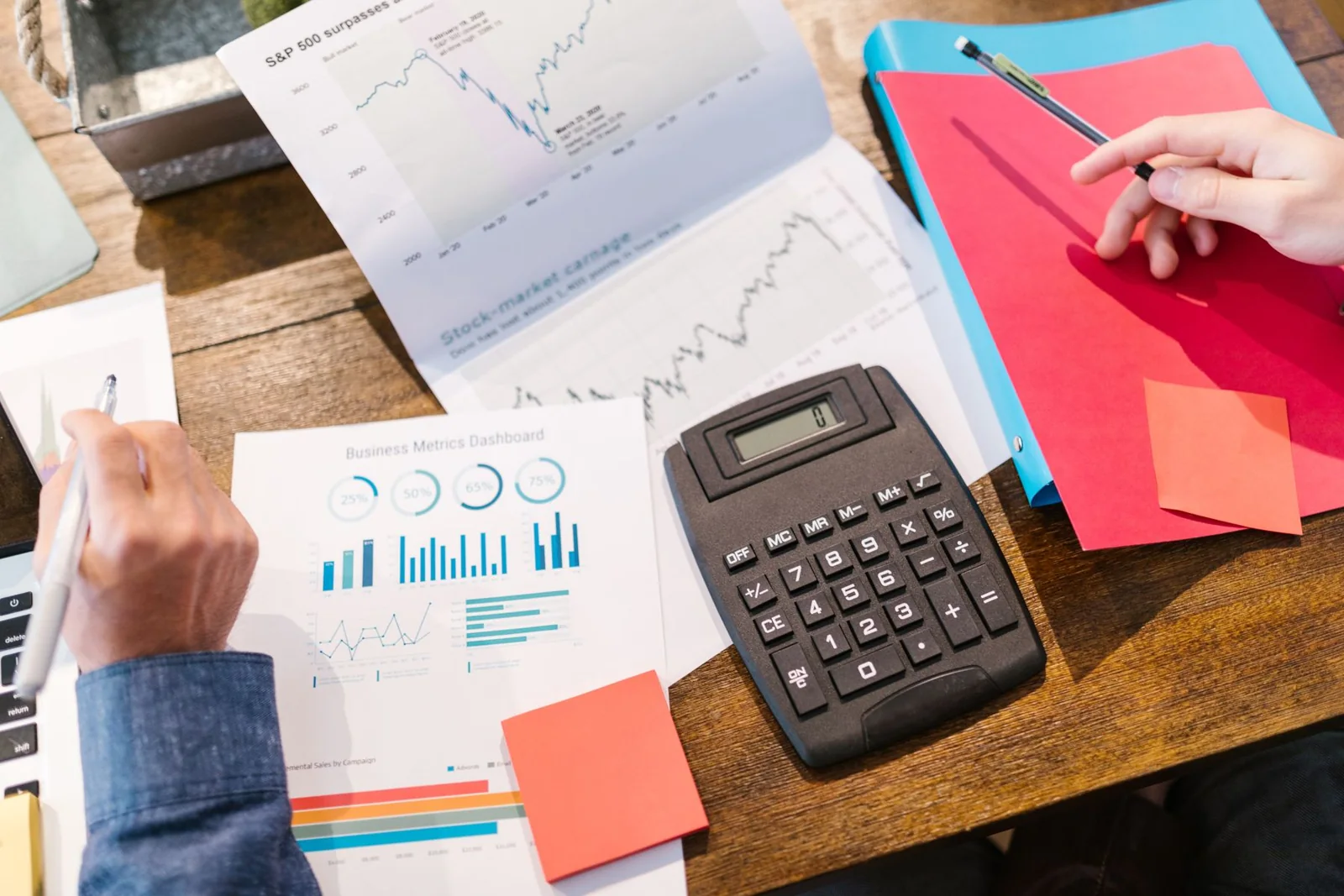 Financial documents, charts, and calculator arranged for capital planning