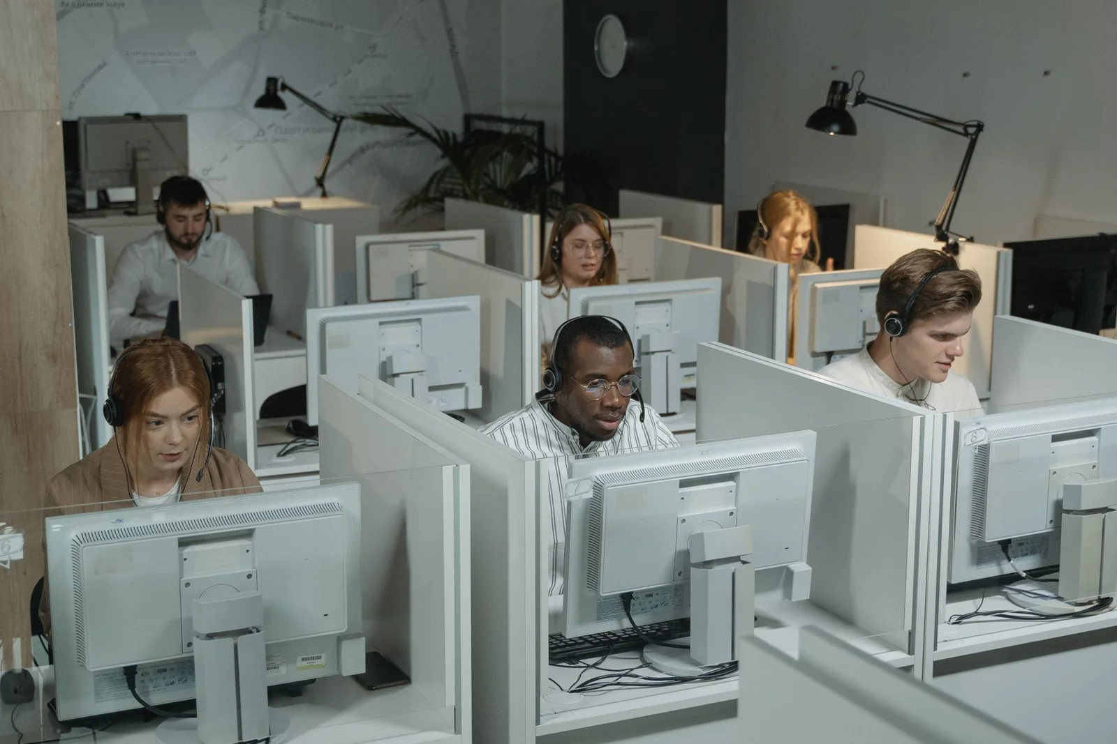 Customer support and digital operations team working together in a modern office