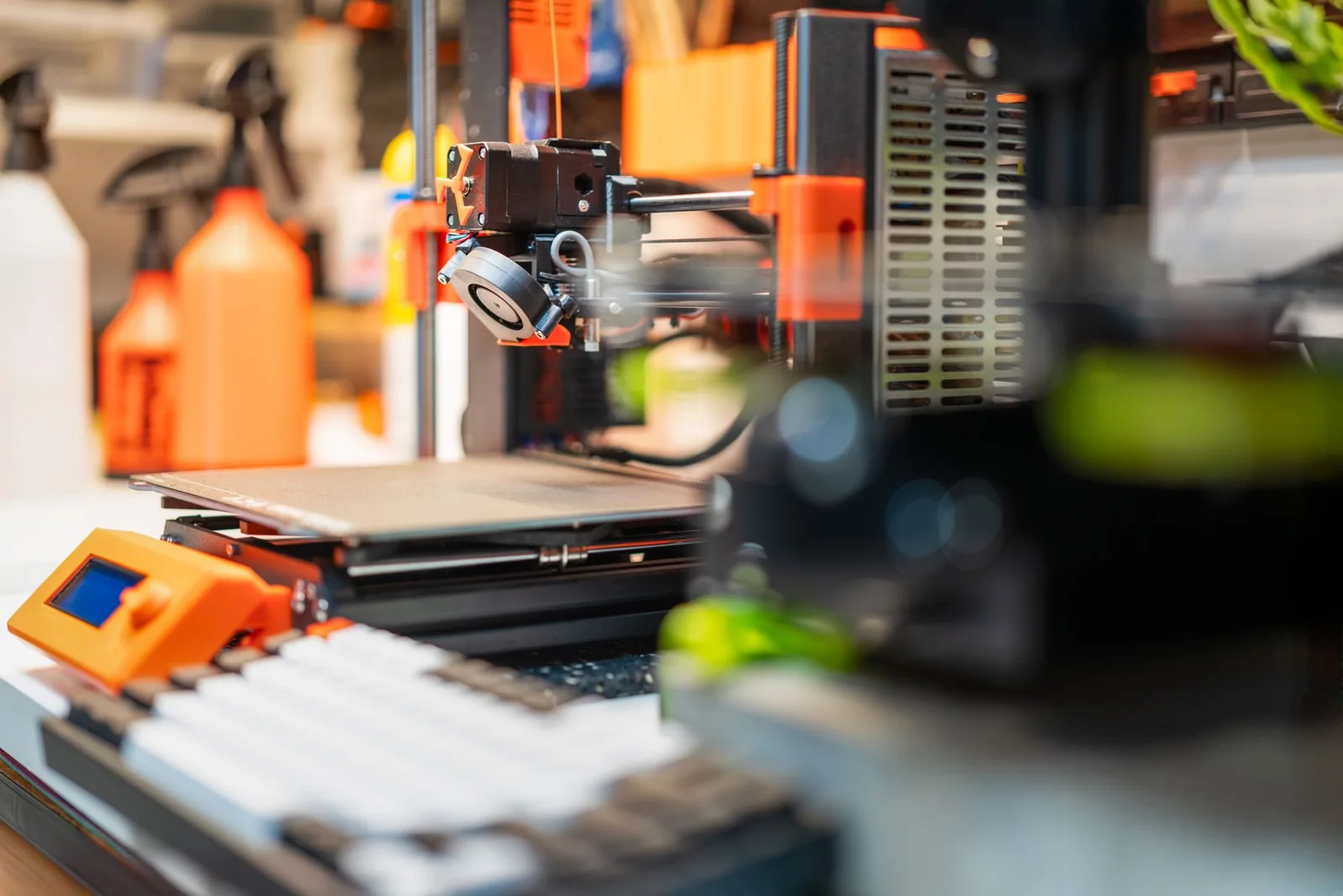 Close view of a 3D printer producing a prototype in a workshop